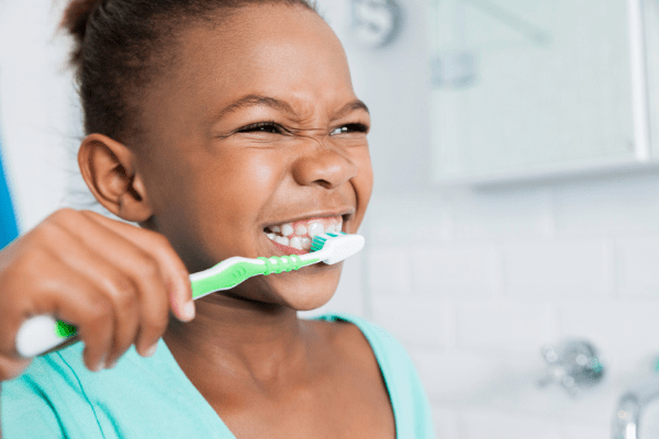 Young girl brushing her teeth