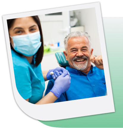 Man smiling in a dentist chair with a dentist